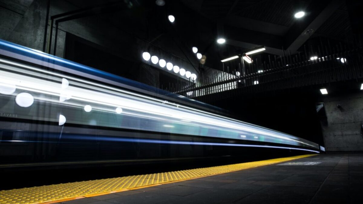 timelapse photography of train passing on track