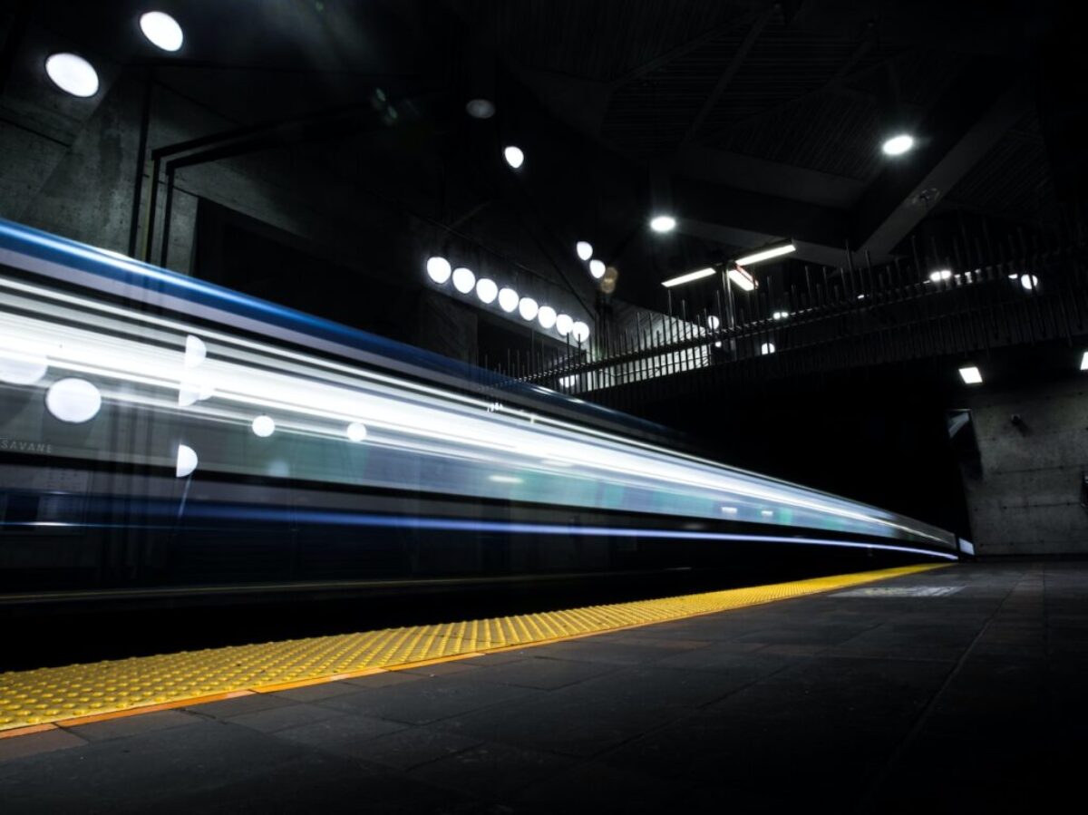 timelapse photography of train passing on track