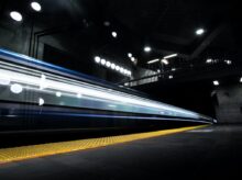 timelapse photography of train passing on track
