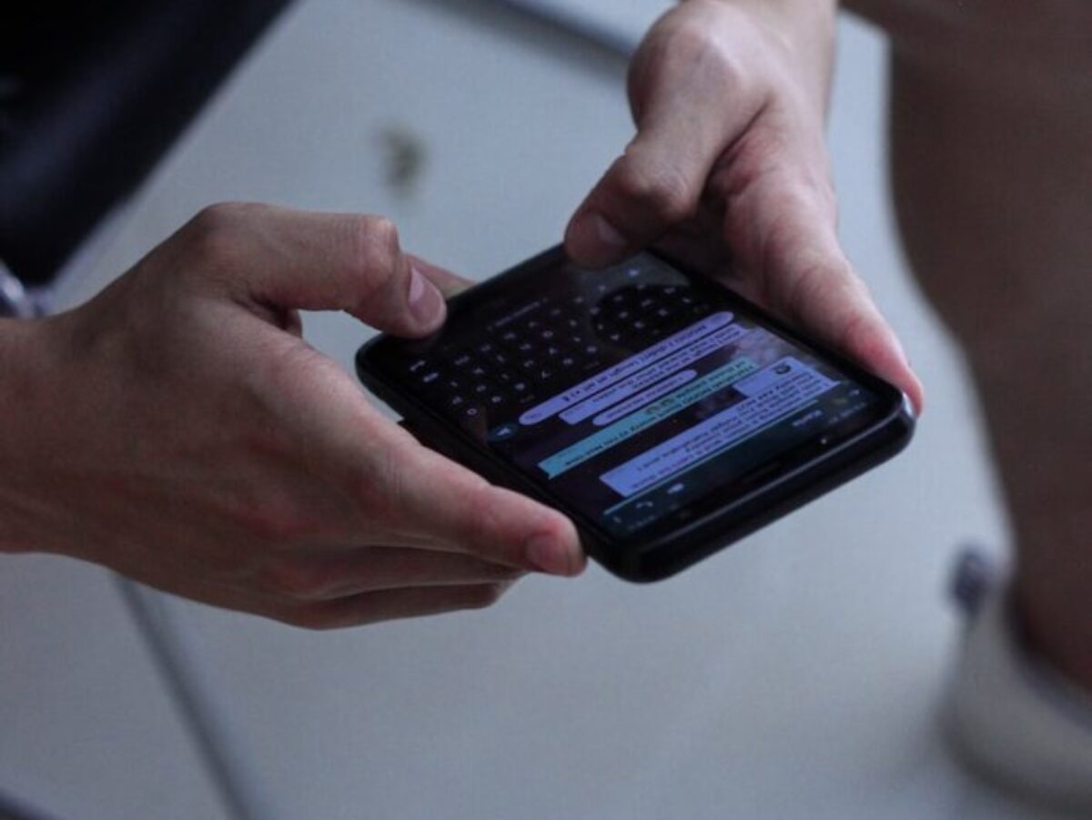 person holding black iphone 4