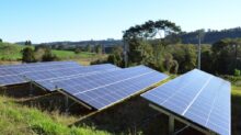 solar panels on green grass field under blue sky during daytime