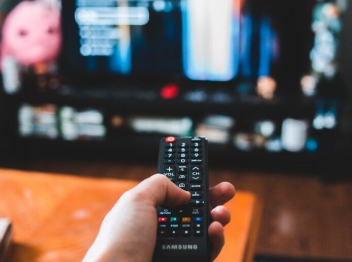person holding black remote control