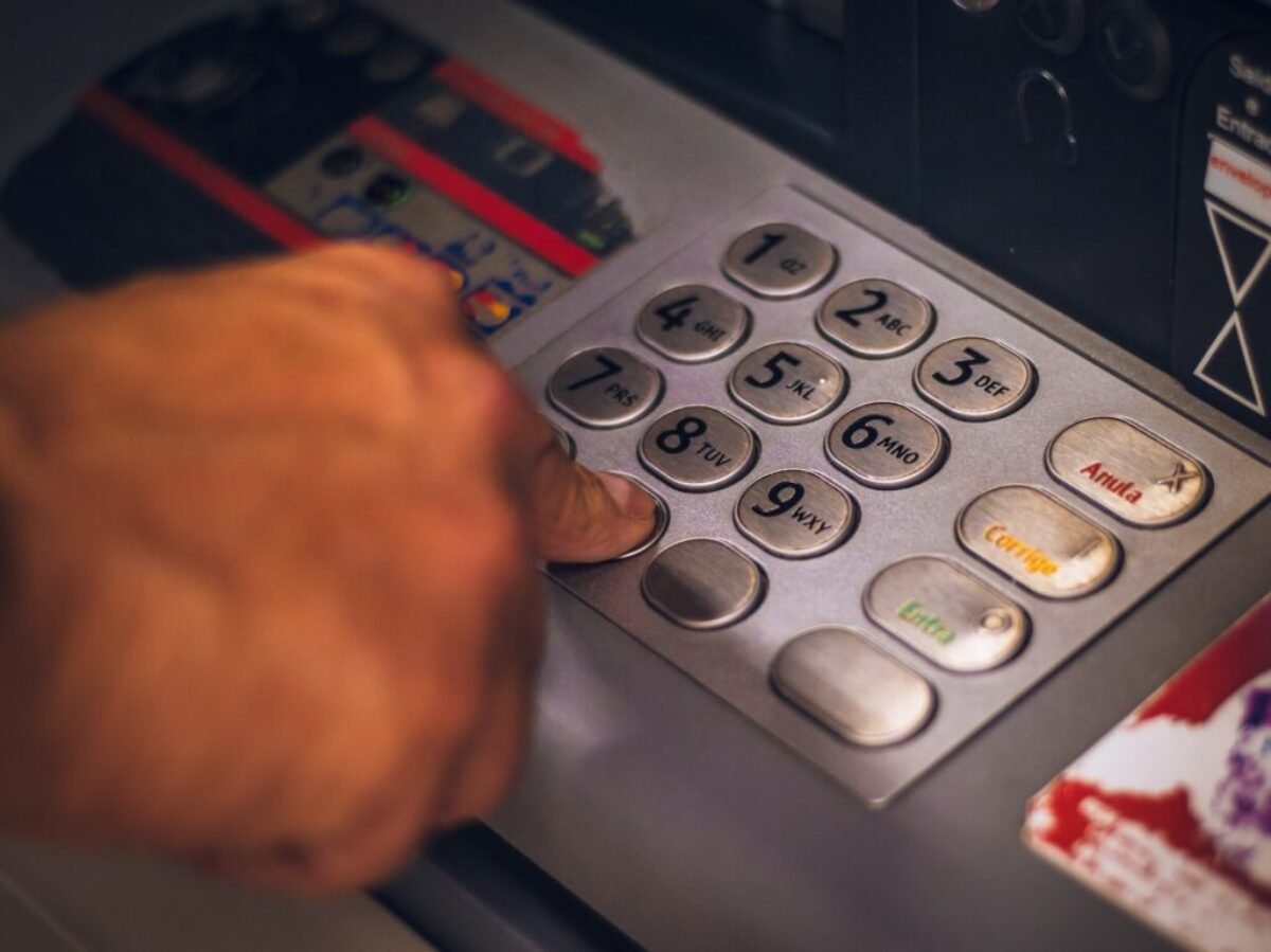 person holding white and red card