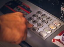person holding white and red card