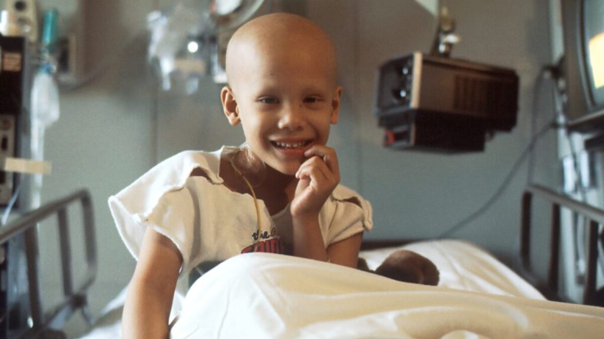 child sitting on bed
