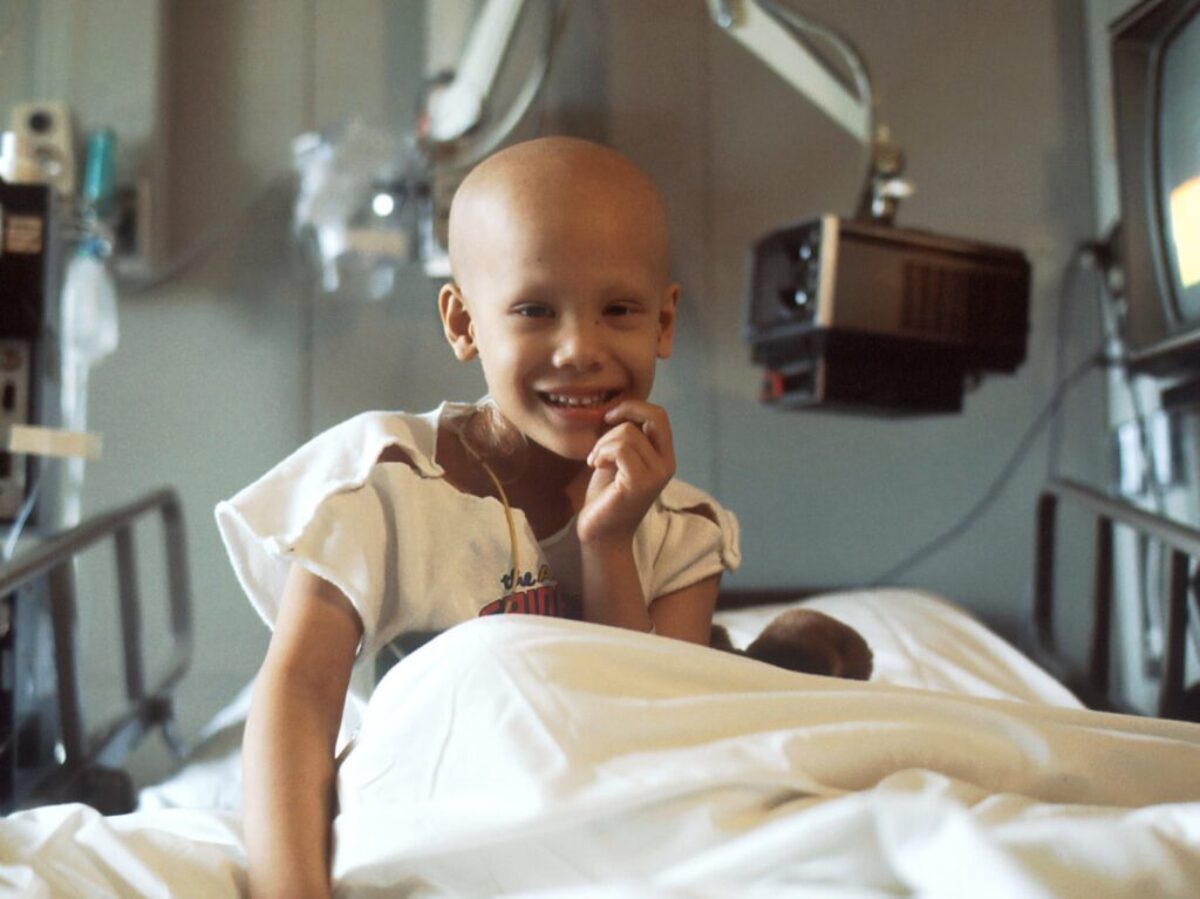 child sitting on bed