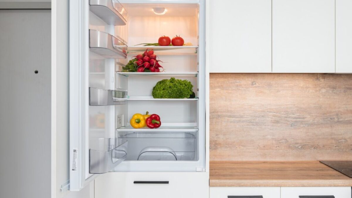 Fridge with different vegetable in modern kitchen