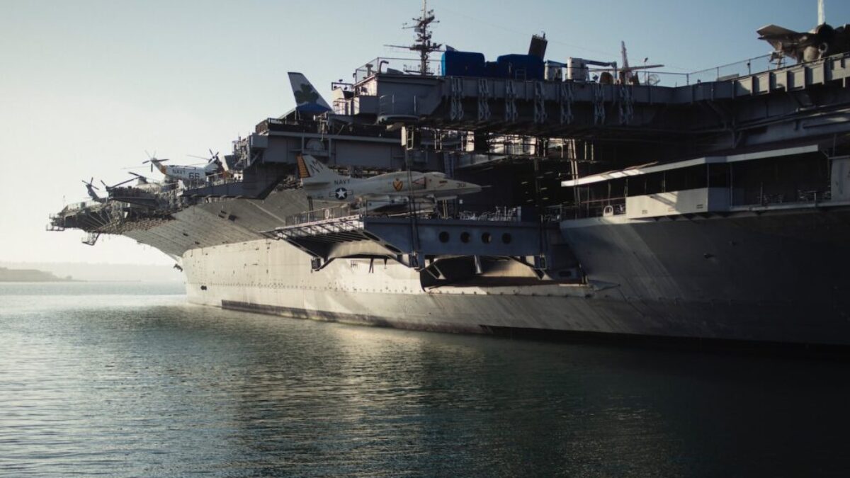 gray warship on body of water