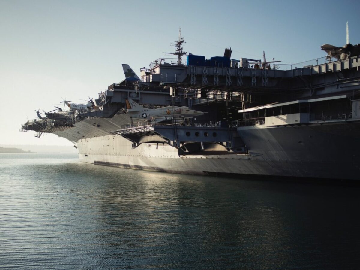 gray warship on body of water