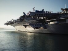 gray warship on body of water