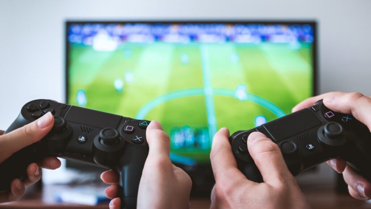 two people playing Sony PS4 game console