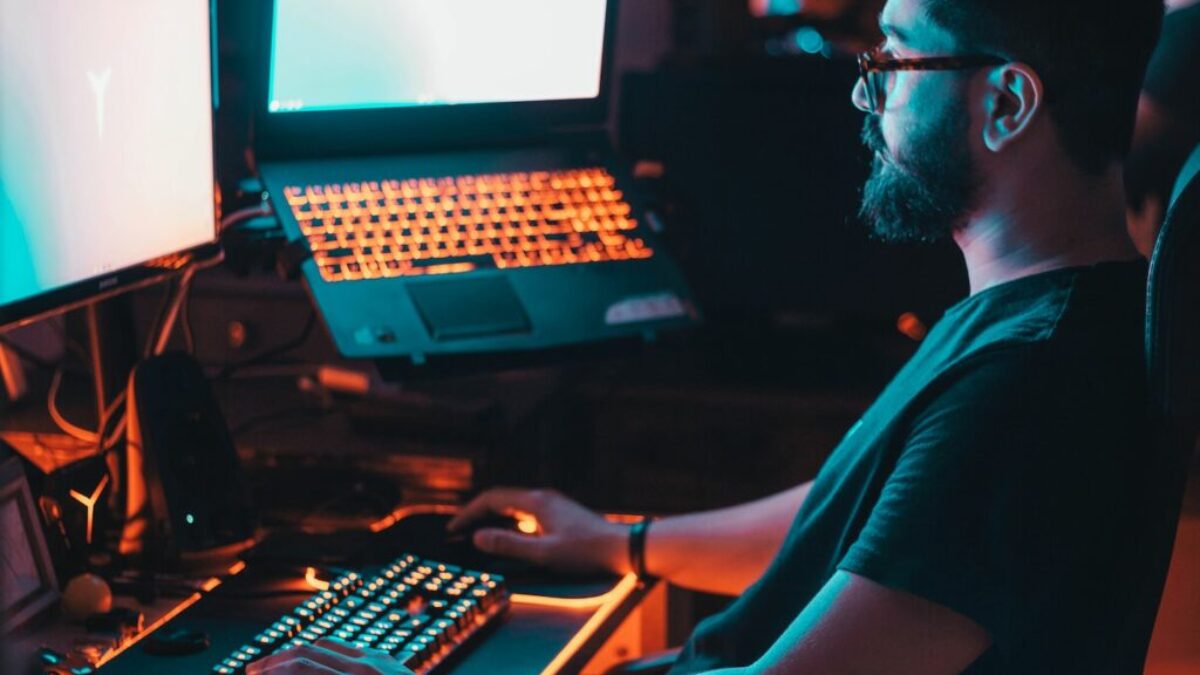 man in blue shirt using computer