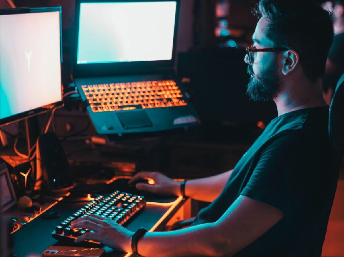 man in blue shirt using computer