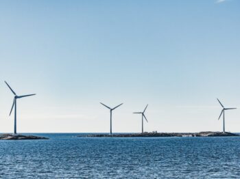 wind turbines on blue sea under blue sky during daytime