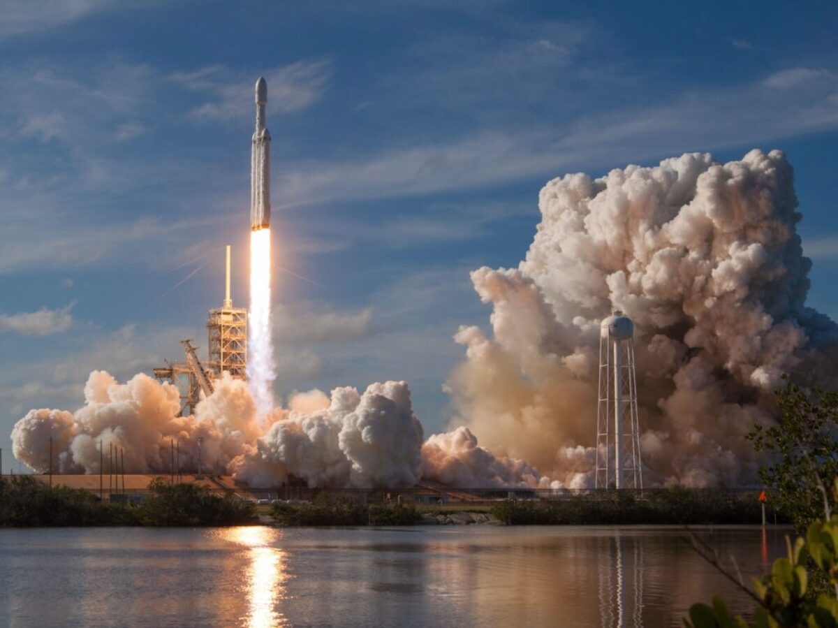 gray spacecraft taking off during daytime