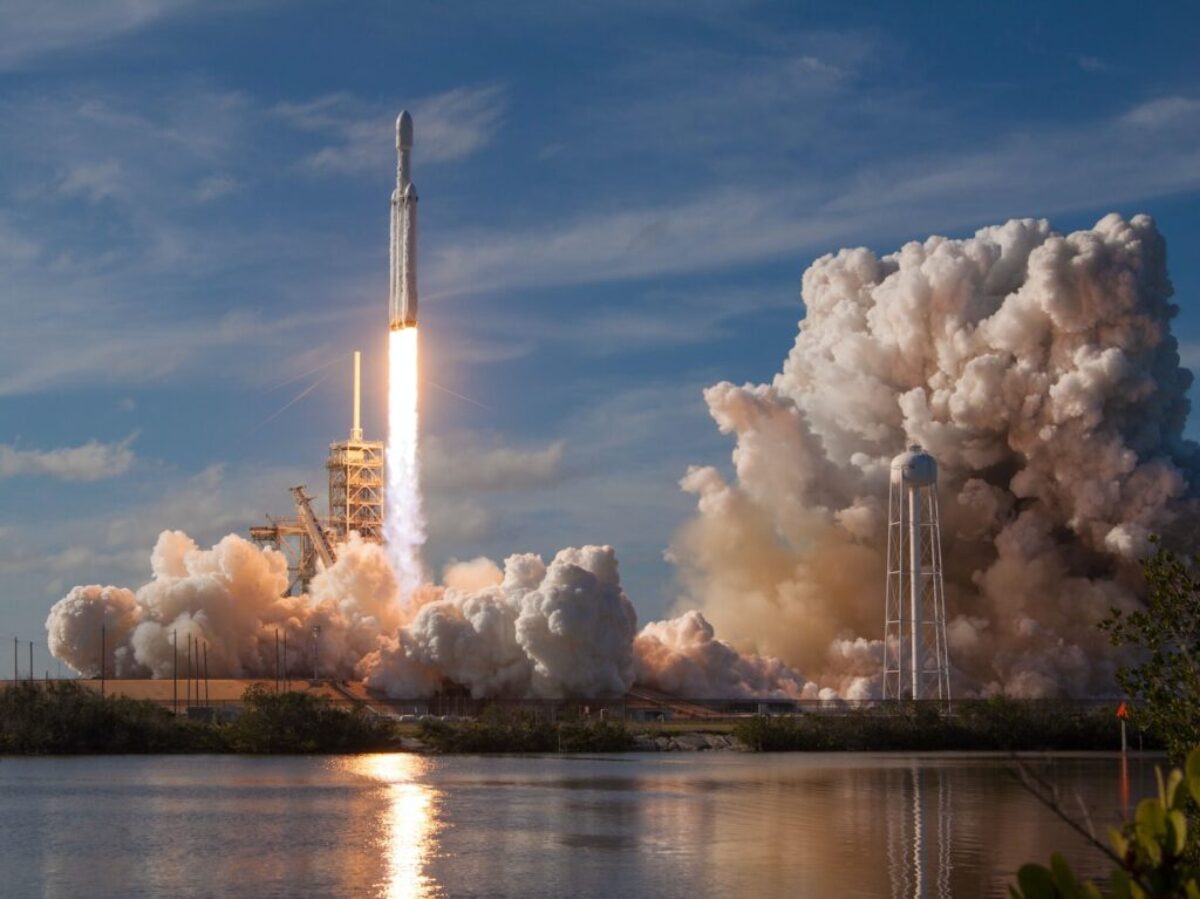 gray spacecraft taking off during daytime