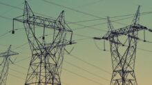 black transmission towers under green sky