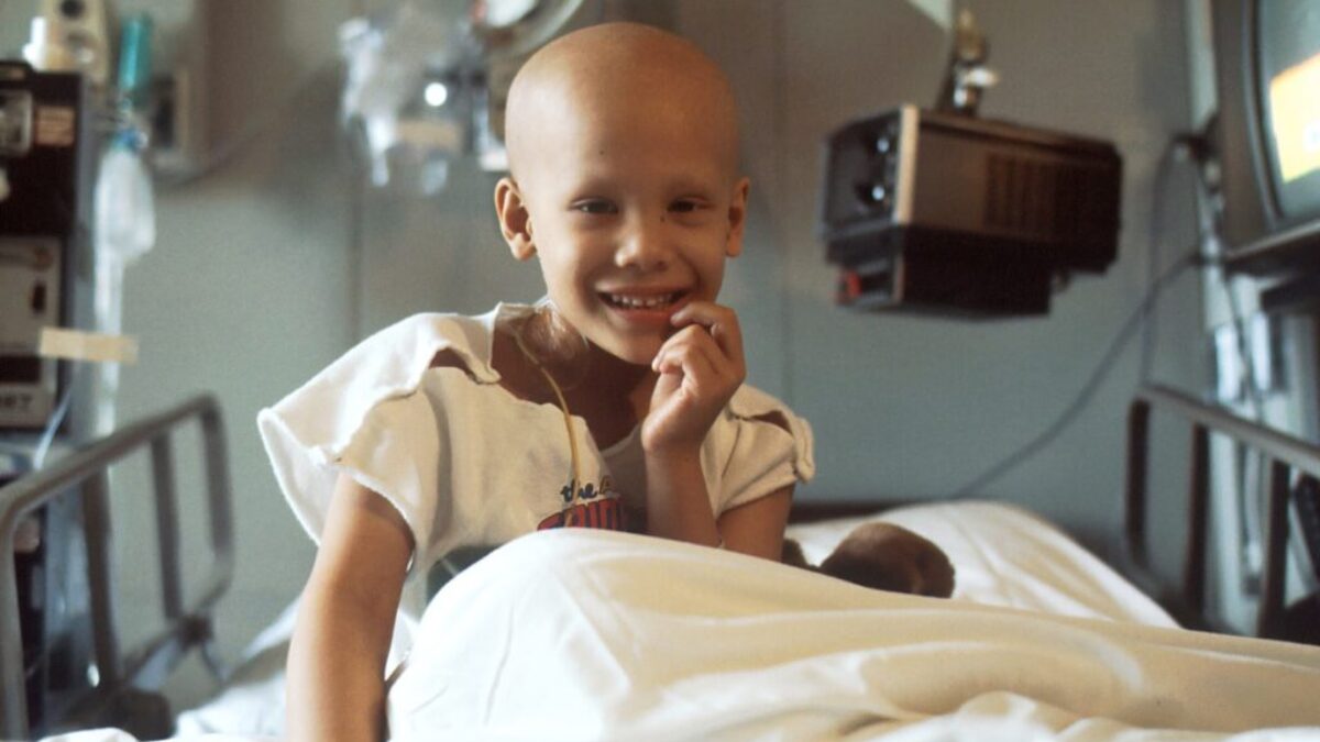 child sitting on bed