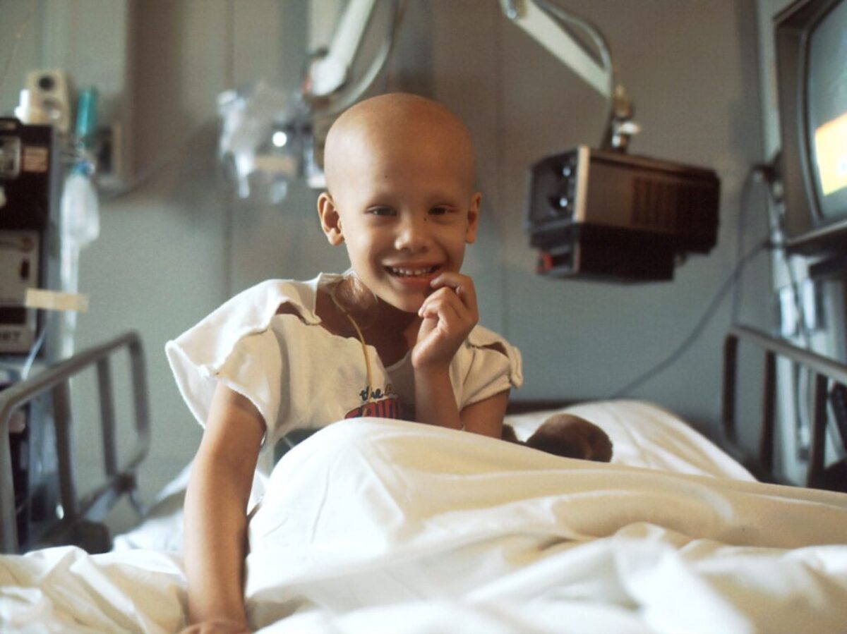 child sitting on bed
