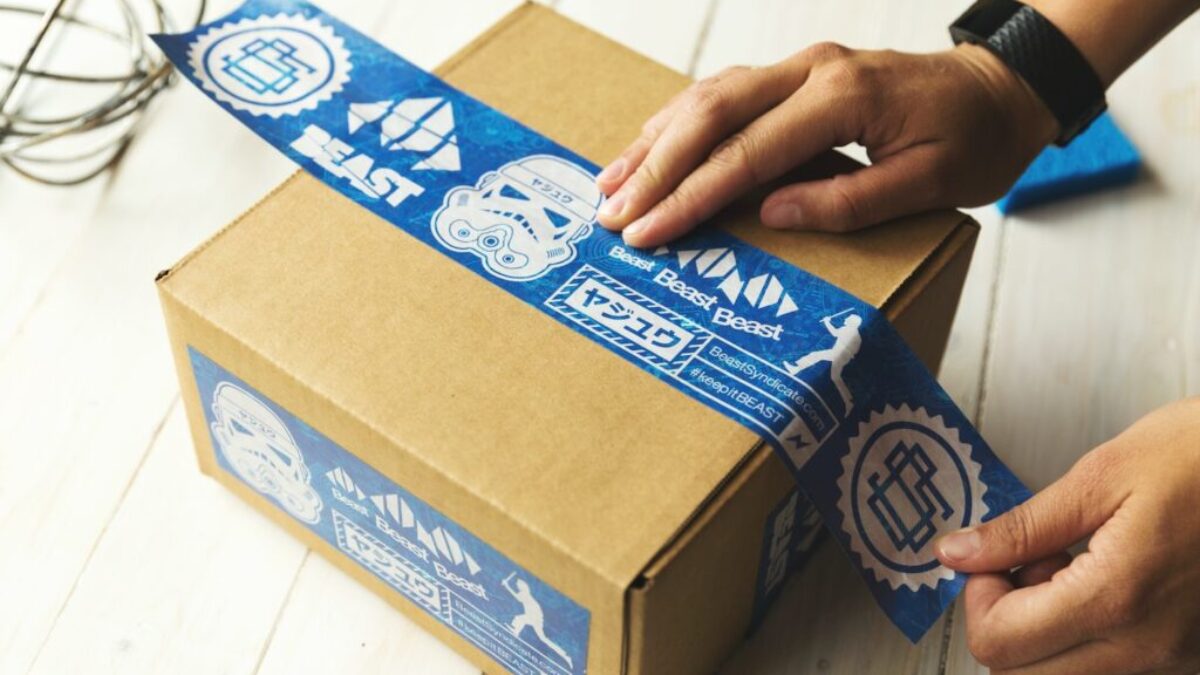 person holding brown and blue box