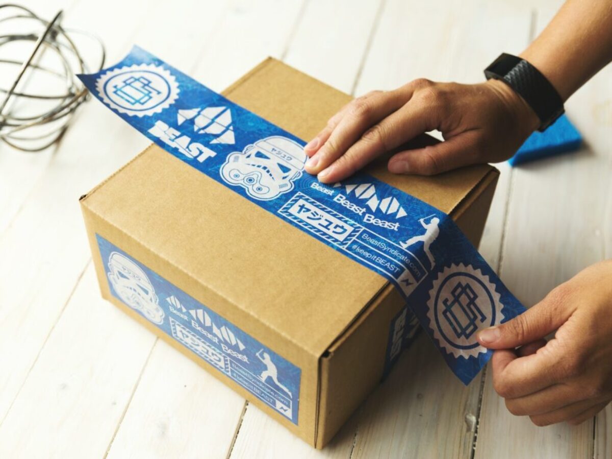 person holding brown and blue box