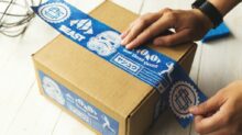 person holding brown and blue box
