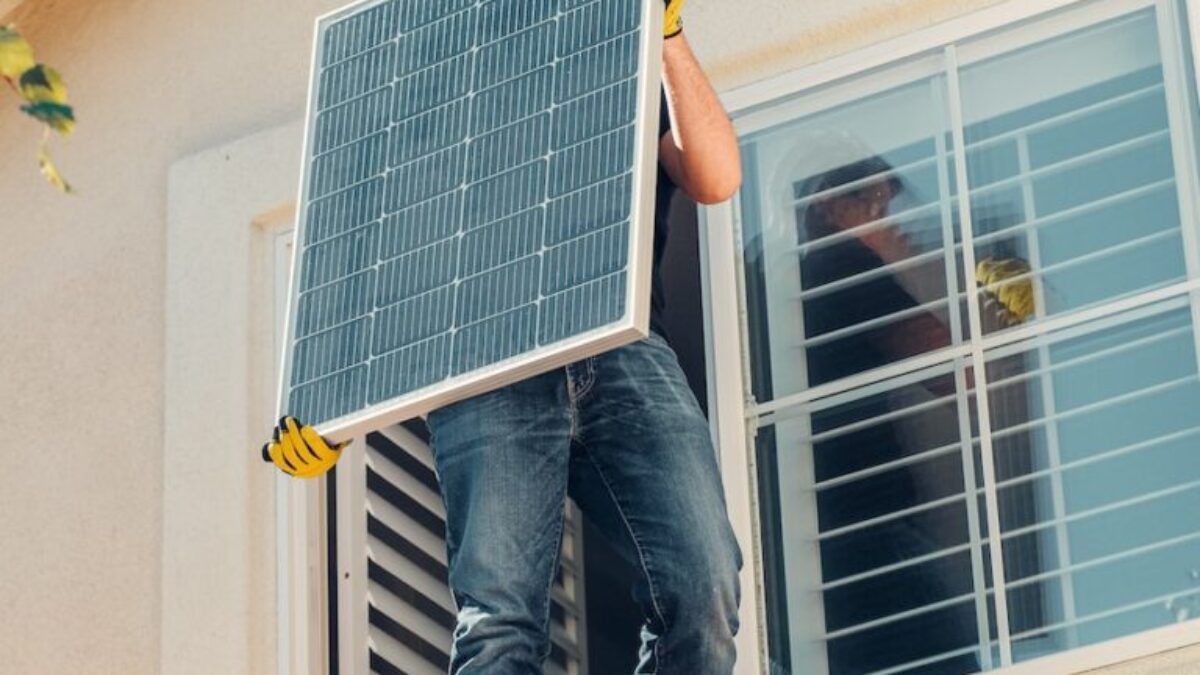 A Man Carrying Solar Panel