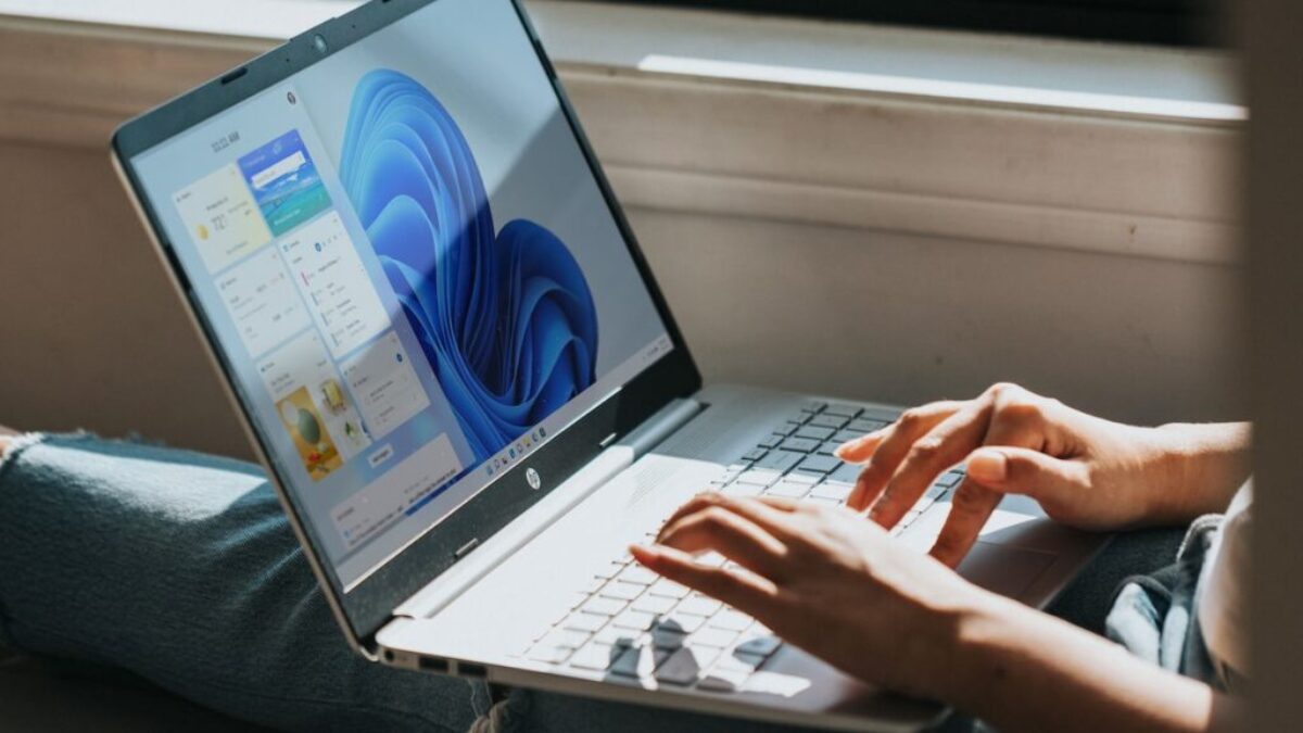 person using Windows 11 computer on lap