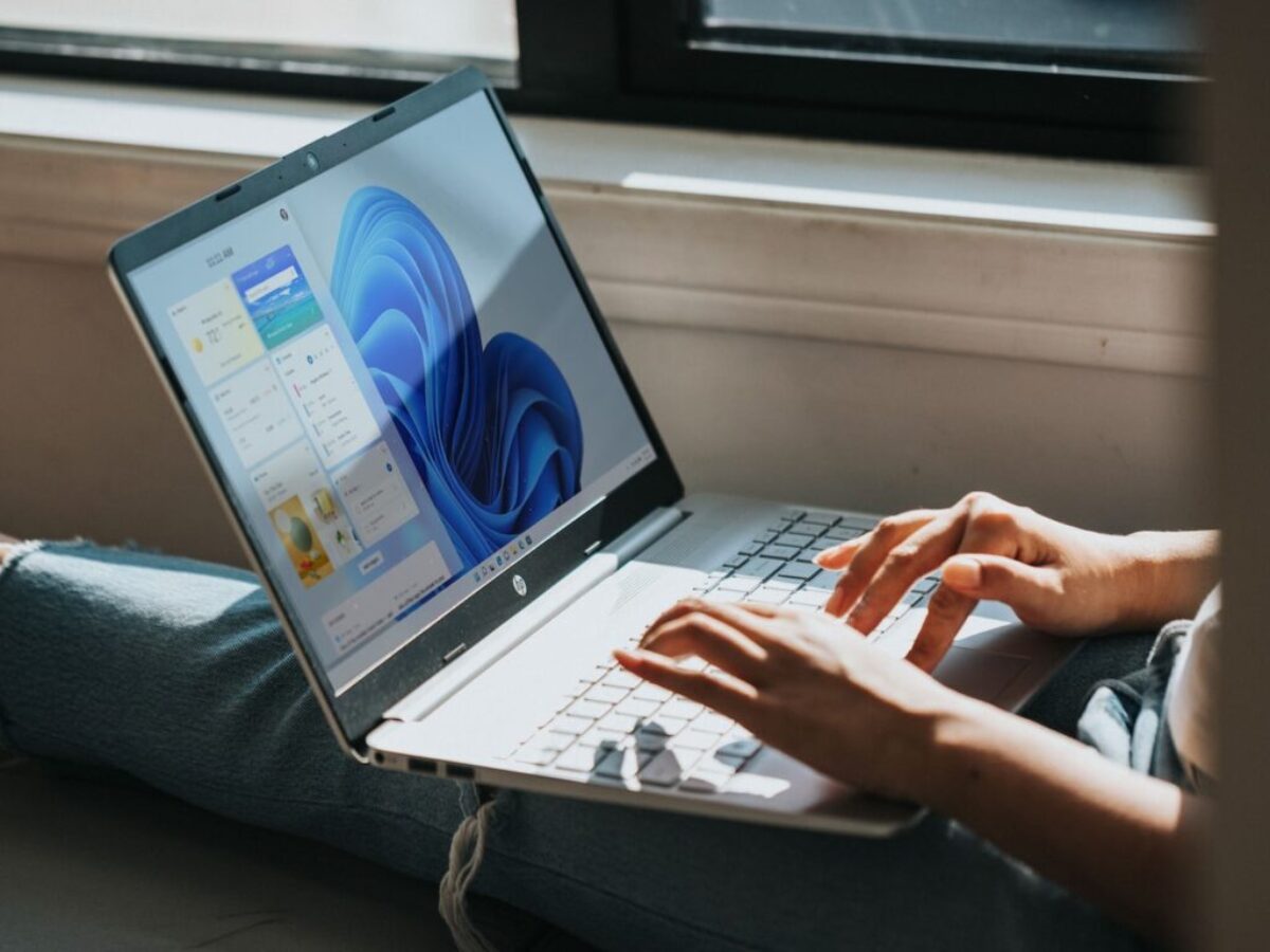 person using Windows 11 computer on lap