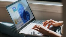 person using Windows 11 computer on lap