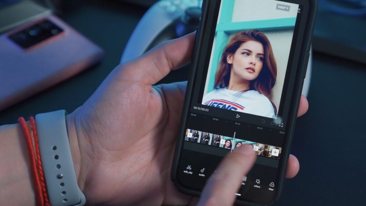 a person holding a cell phone with a picture of a woman on the screen