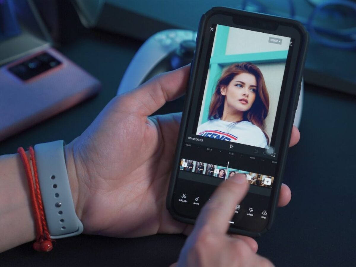a person holding a cell phone with a picture of a woman on the screen