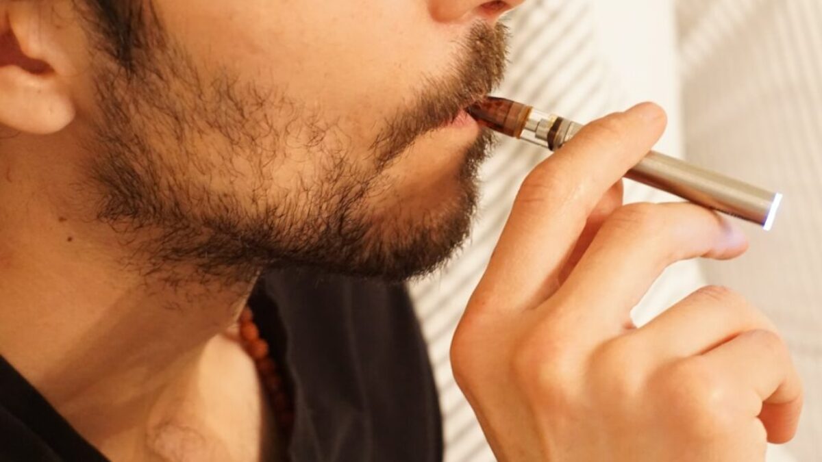 man in black shirt smoking cigarette