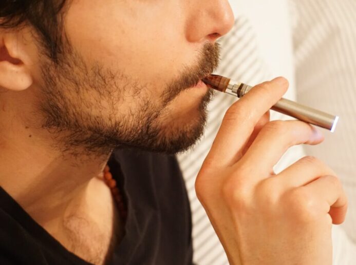 man in black shirt smoking cigarette