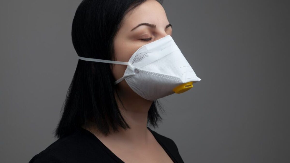 woman in black shirt with white mask