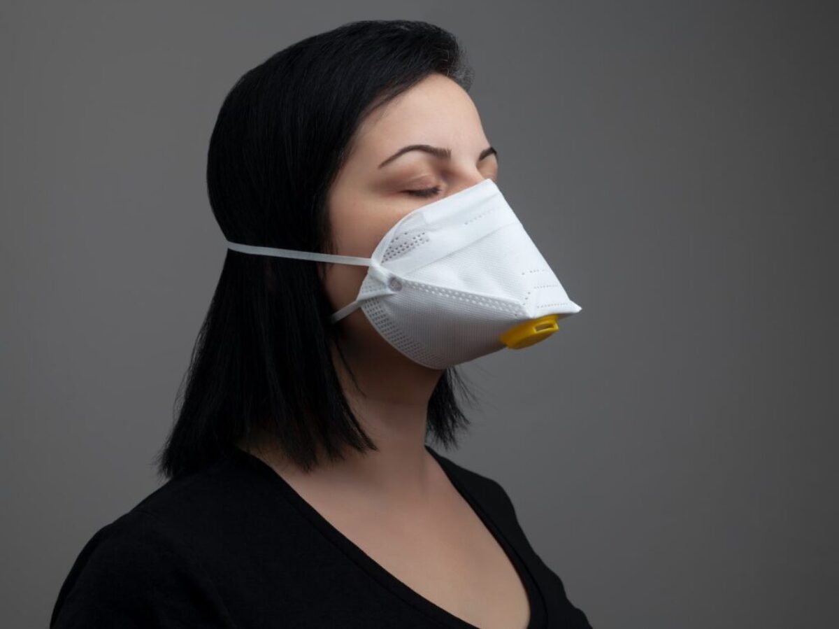 woman in black shirt with white mask
