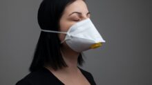 woman in black shirt with white mask