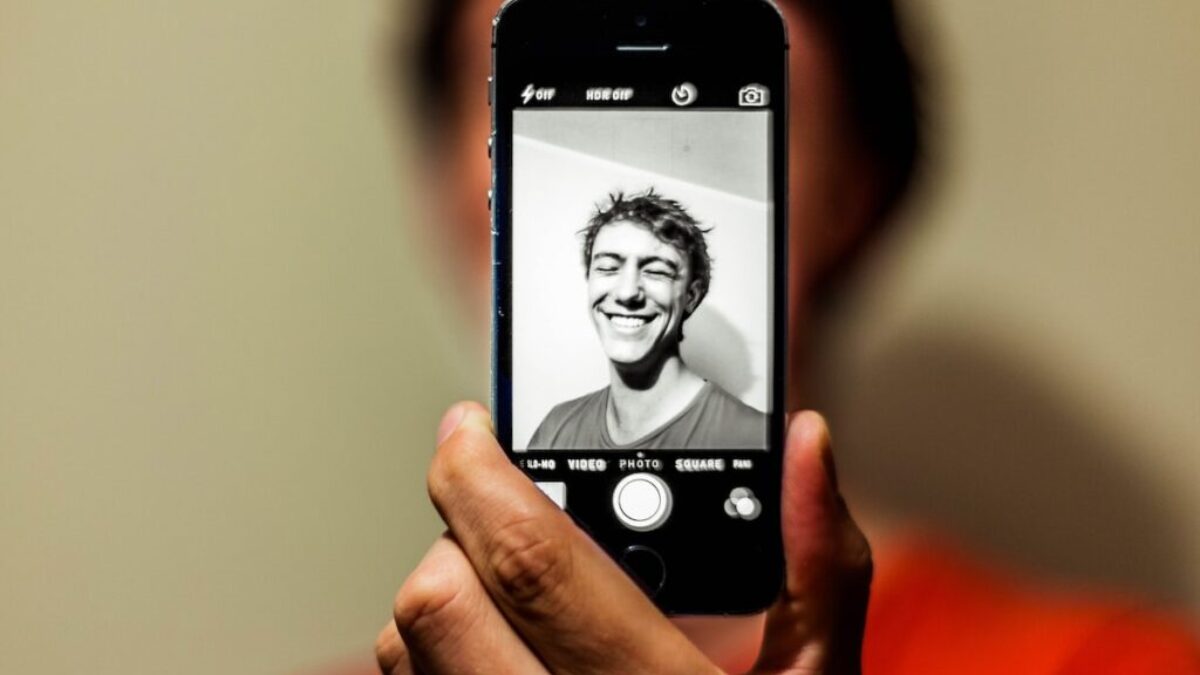 person holding space gray iPhone 5s taking picture