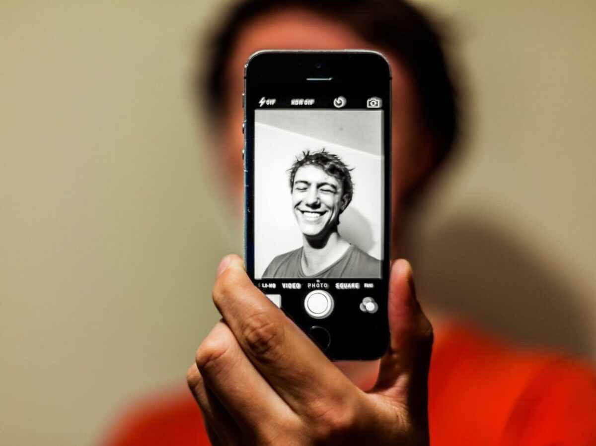 person holding space gray iPhone 5s taking picture