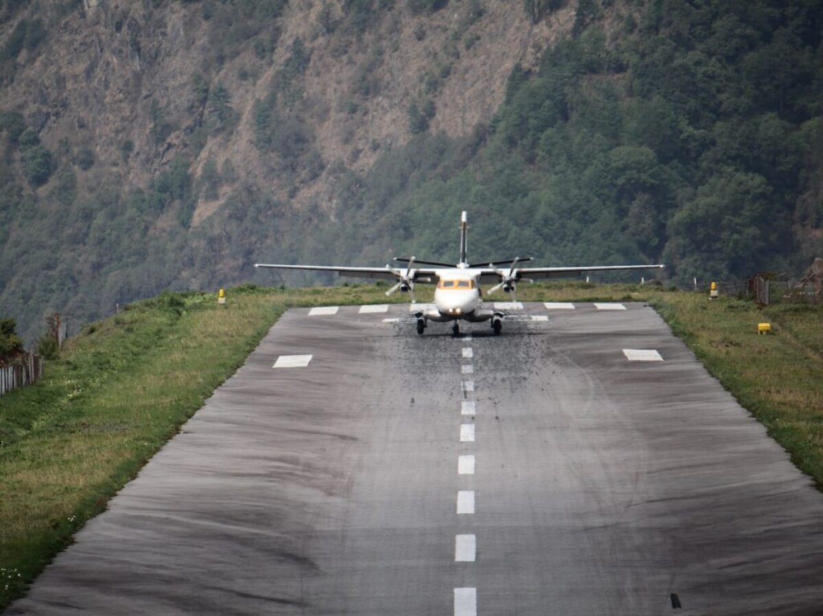 white and yellow plane on gray asphalt road during daytime