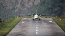 white and yellow plane on gray asphalt road during daytime