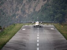 white and yellow plane on gray asphalt road during daytime