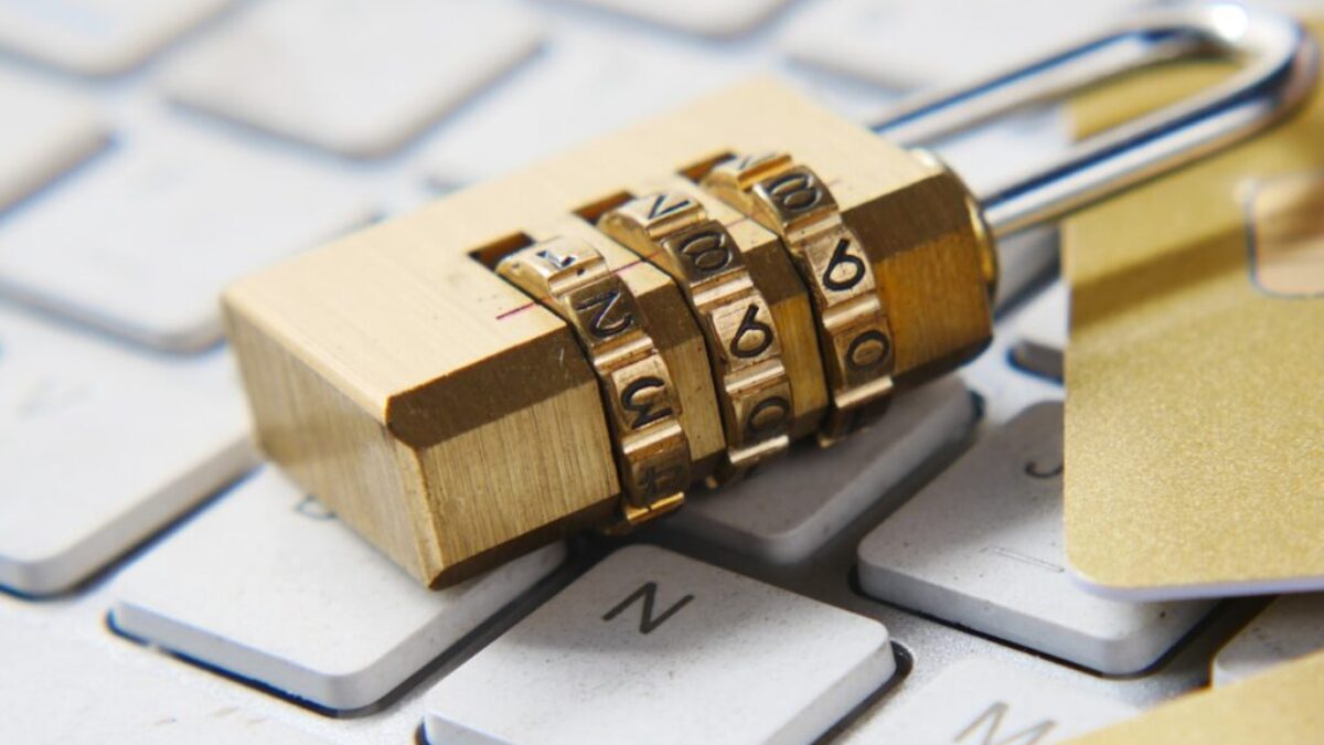a golden padlock sitting on top of a keyboard