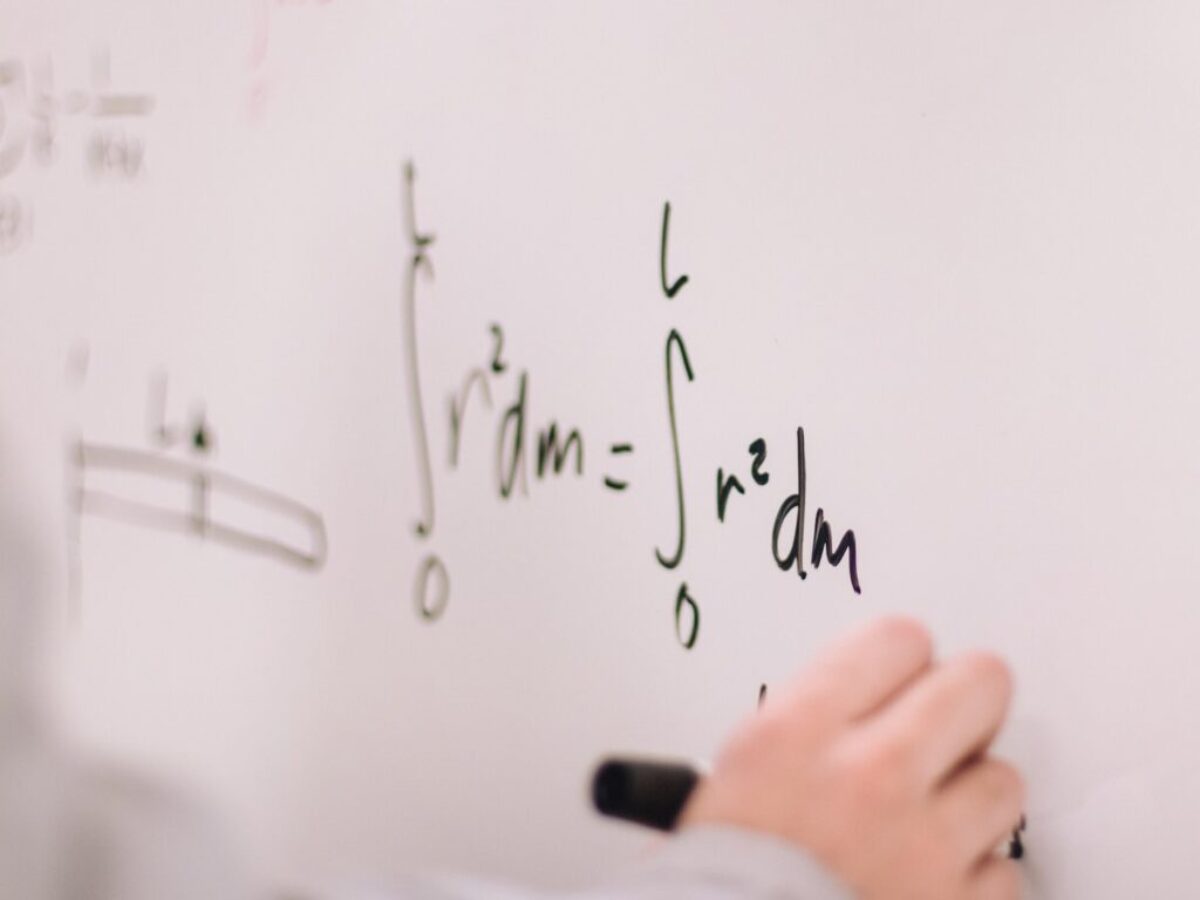person writing on white paper