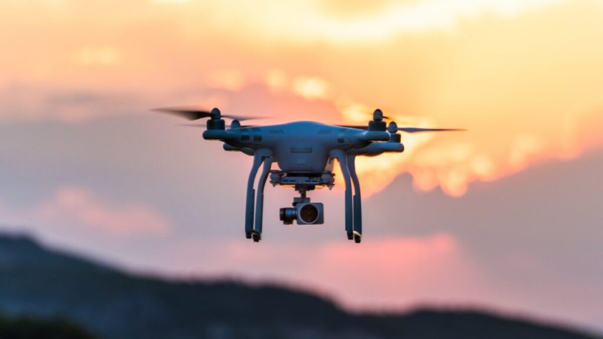 white quad-copter drone during golden hour
