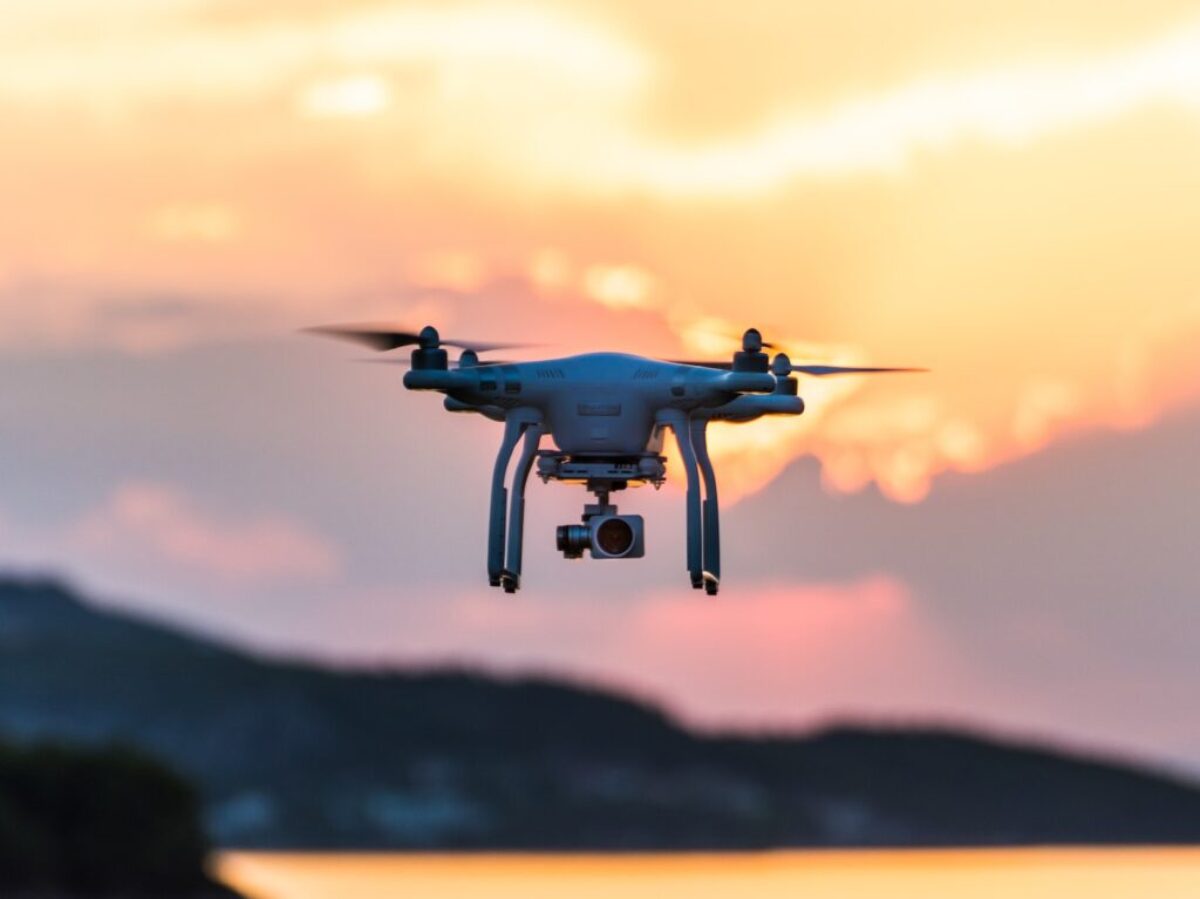 white quad-copter drone during golden hour