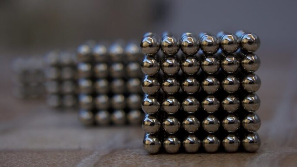 silver beads on brown wooden table