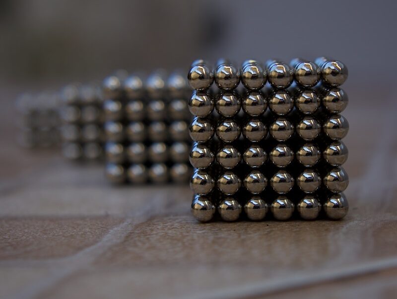 silver beads on brown wooden table