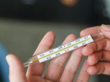 Person Holding Thermometer