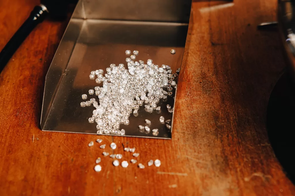 a pile of white beads sitting on top of a wooden table